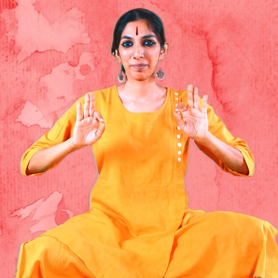 Priya with both open palms held forward at her chest